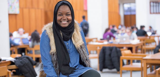 student smiling in the library