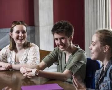 Students talking around table