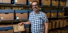 James Cassaro stands in front of a shelf of film archives