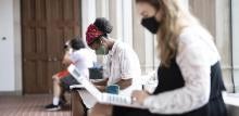 Two student wearing masks study 