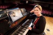 Adriana Helbig seated at a grand piano